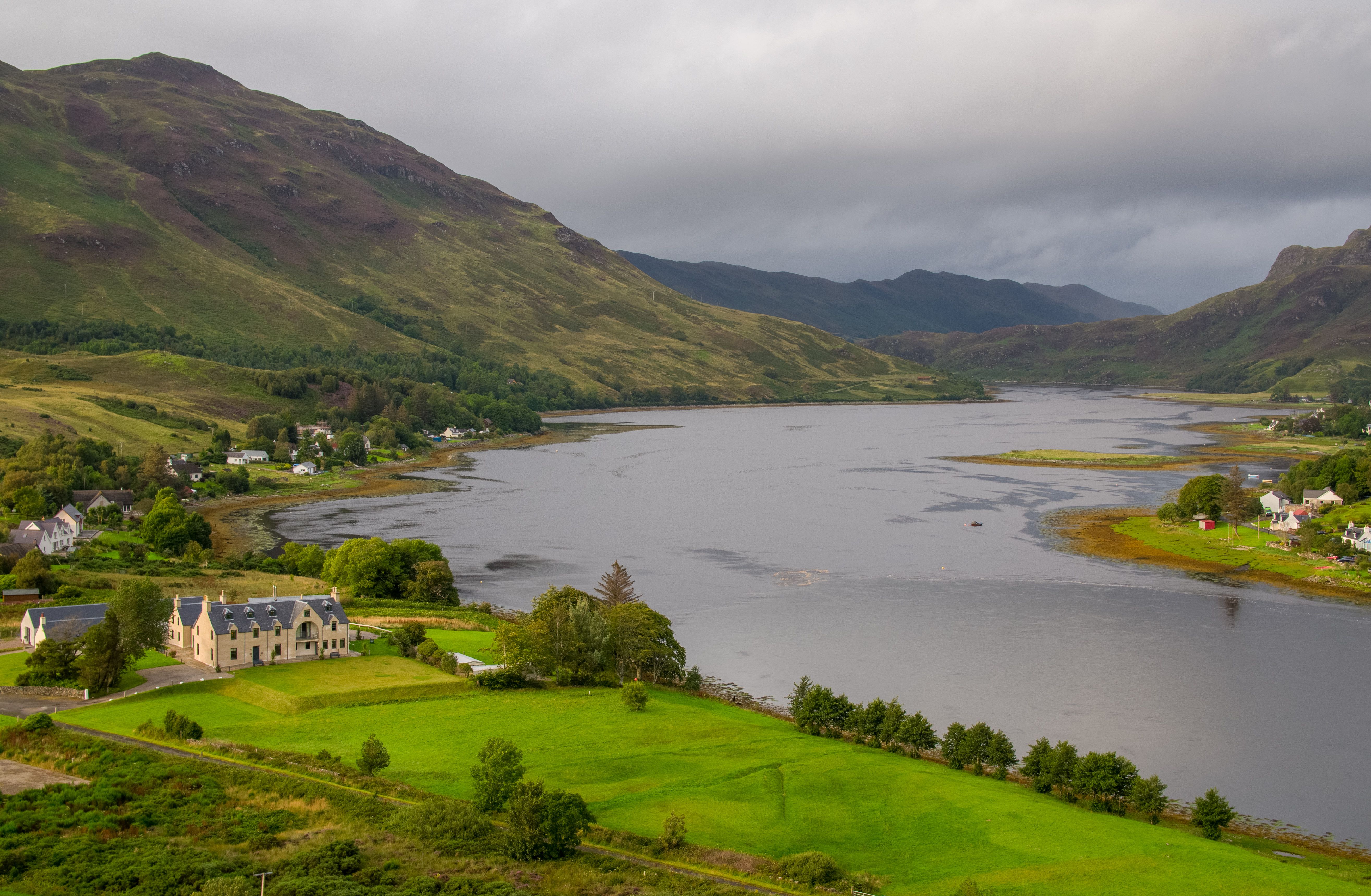 Highland loch beneath rolling mountains and an overcast sky