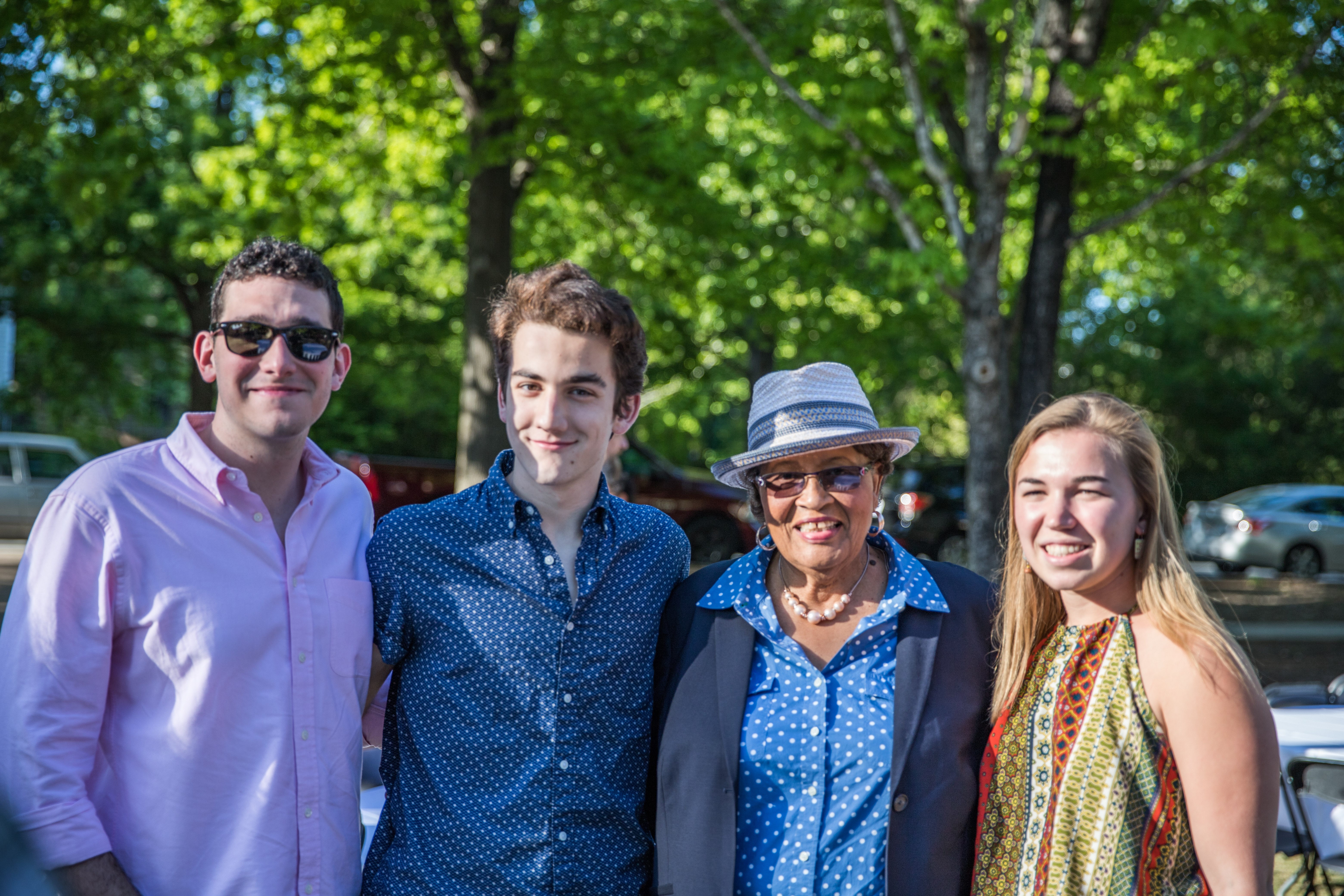 Young people posing with a Congresswoman at an outdoor community event